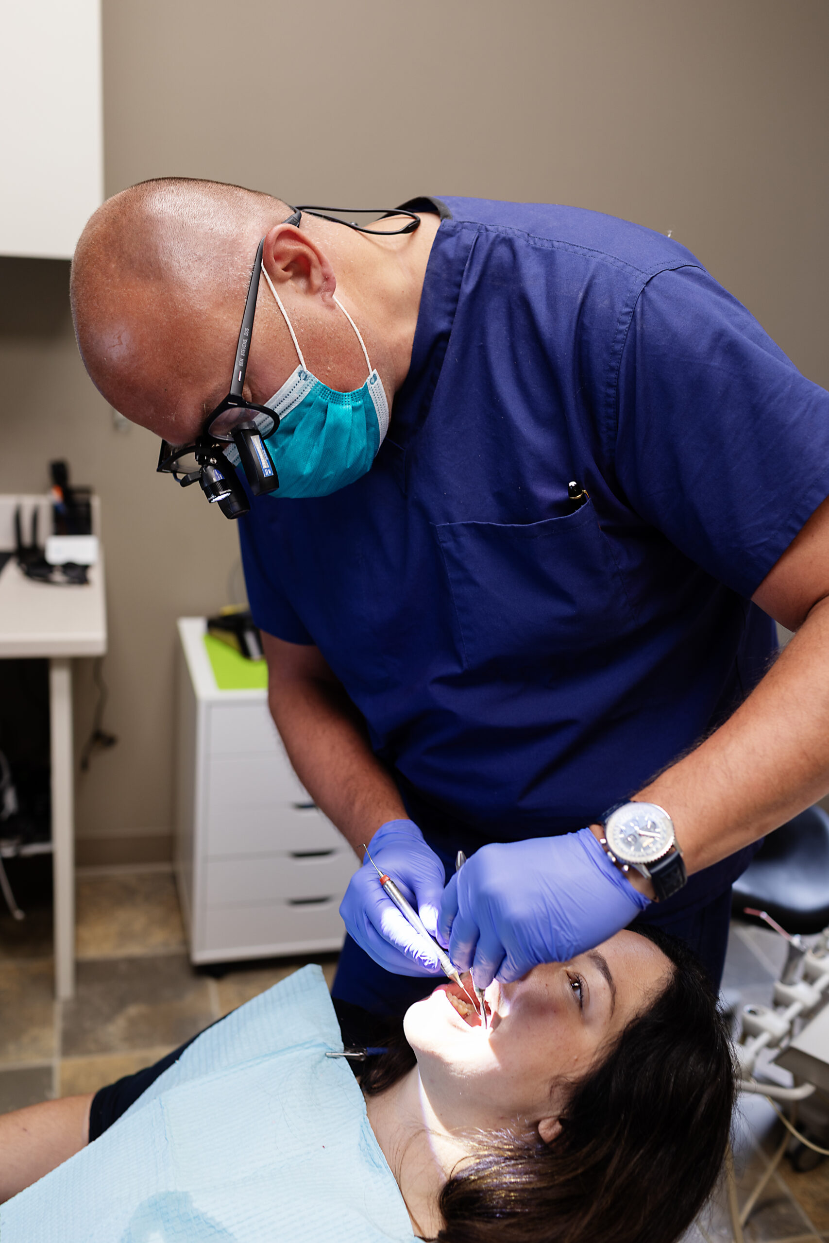 Dr. Ben Stevens is working on a female dental patient